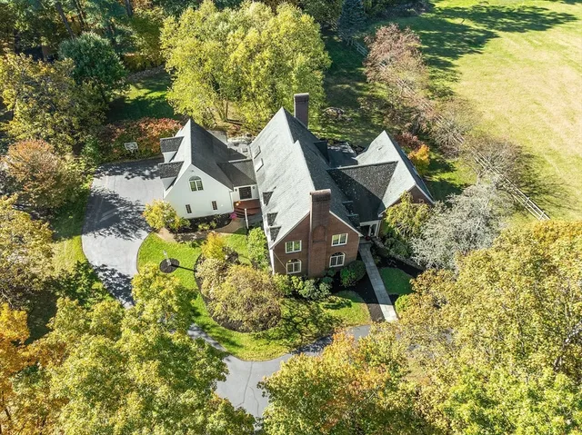 a aerial view of a house with pool and garden