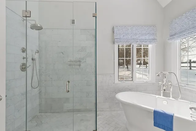 a spacious bathroom with a shower sink and mirror