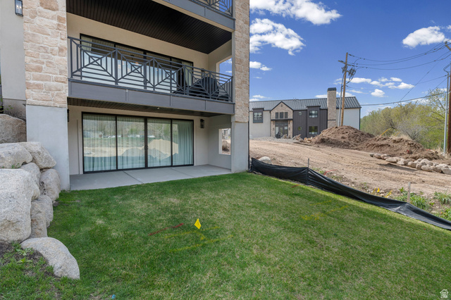 250 South Main Street, Unit 24 Alpine, UT 84004 - Photo 42 of 50 Rear view of house with a patio area, a balcony, stucco siding, a lawn, and stone siding