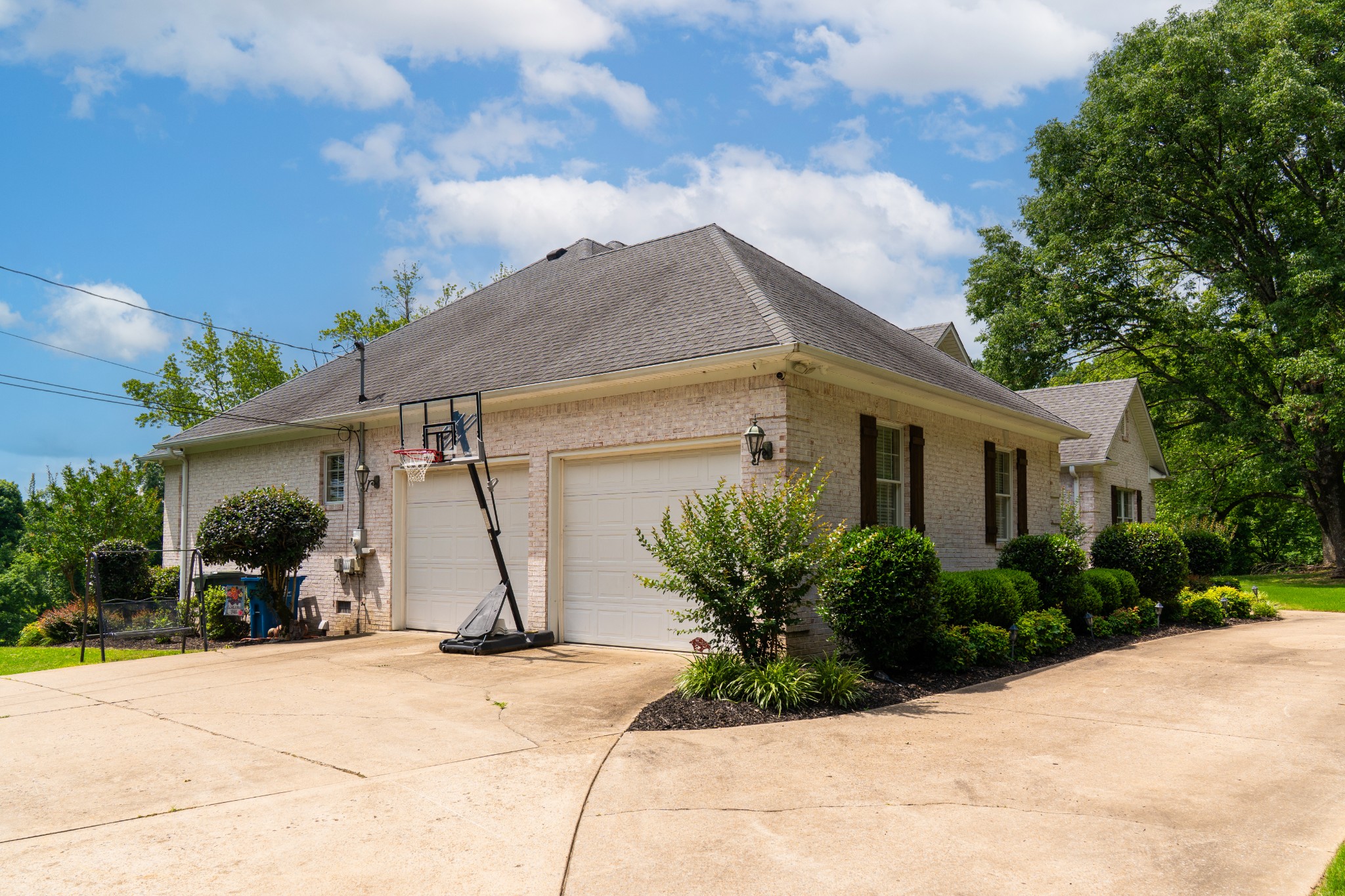 1015 Kelly Road Dyersburg, TN 38024 - Photo 4 of 41 a view of a white house with a yard and plants