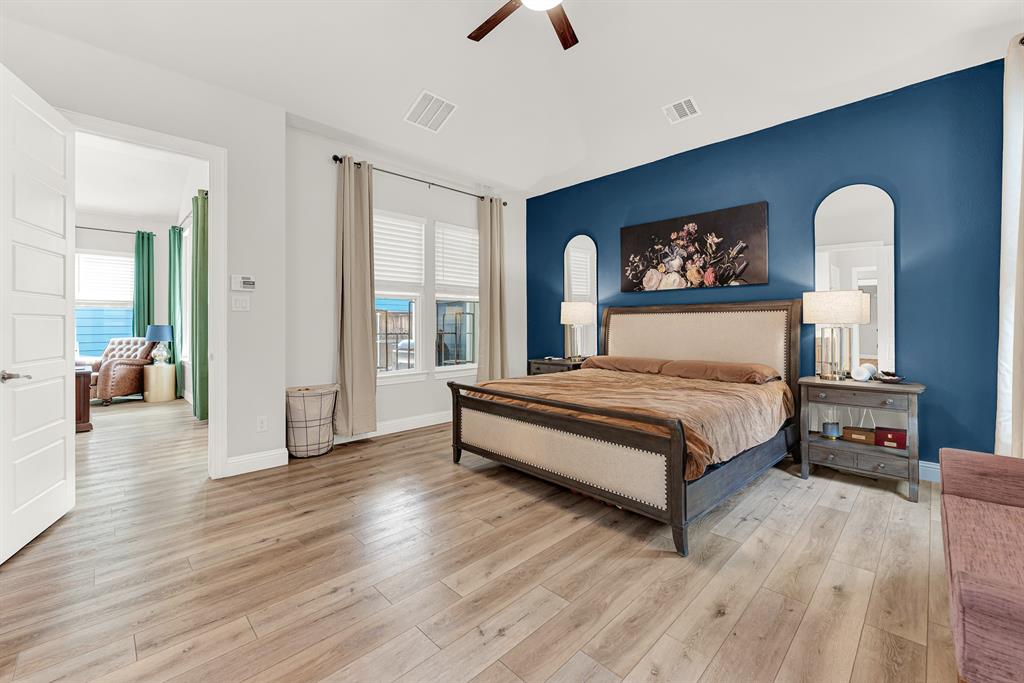 6404 Trezevant Street Rowlett, TX 75089 - Photo 16 of 30 a bedroom with a bed and a chandelier