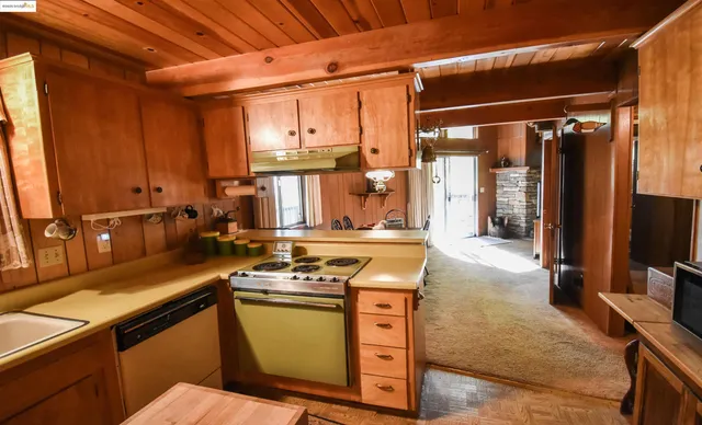 a kitchen with stainless steel appliances a stove a sink and a refrigerator