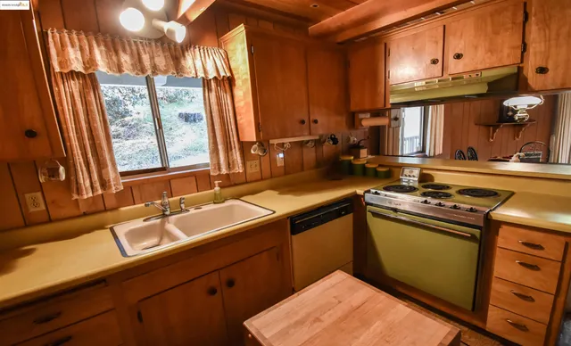 a kitchen that has a sink and a stove