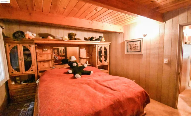 a bed sitting in a bedroom next to a window