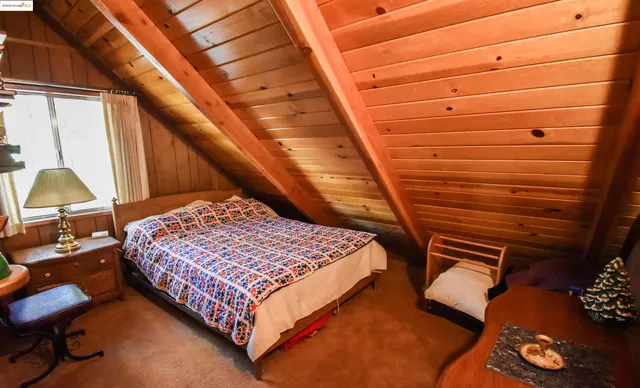 a bed sitting in a bedroom next to a window