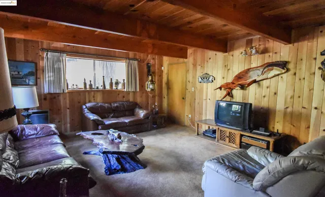 a living room with furniture a air conditioner vent and a window