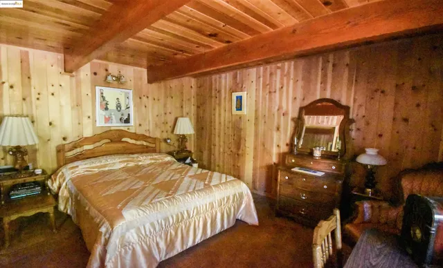 a bedroom with a bed and a mirror