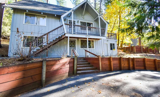 a view of a house with wooden fence