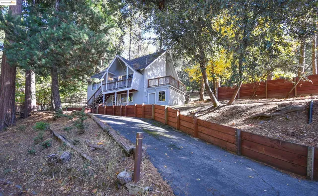 a view of a house with large trees