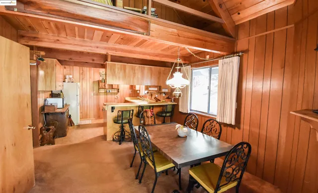 a view of a dining room with furniture and a chandelier