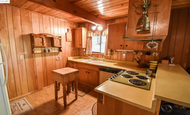 a kitchen with a sink appliances and cabinets