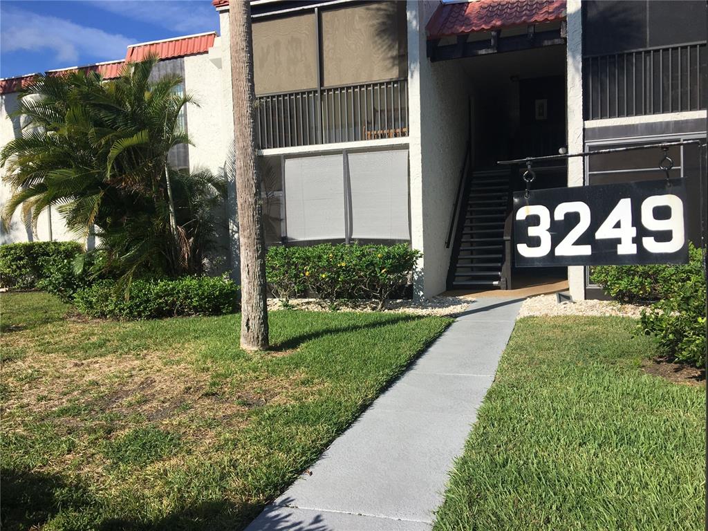 3249 South Beneva Road, Unit 102 Sarasota, FL 34232 - Photo 1 of 1 a front view of a house with garden