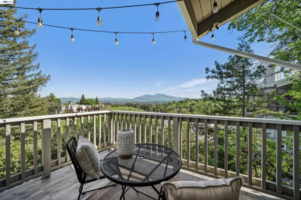 a view of a balcony with mountain view and wooden floor
