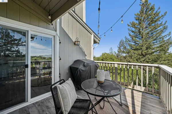 a balcony with table and chairs