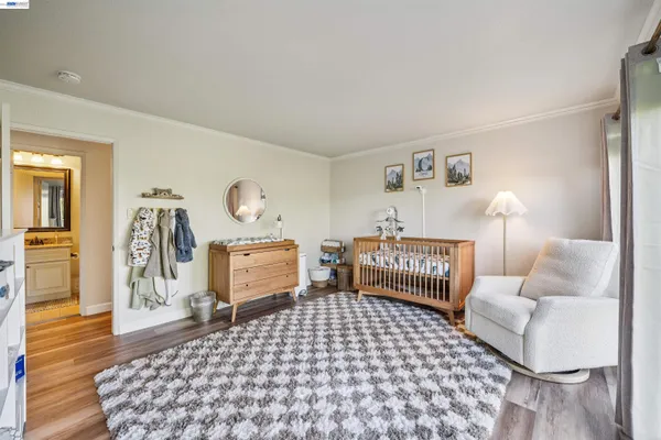 a bedroom with furniture and wooden floor