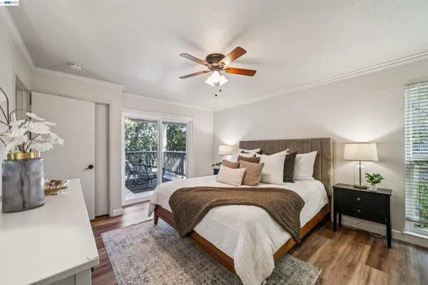 a bedroom with bed and a chandelier