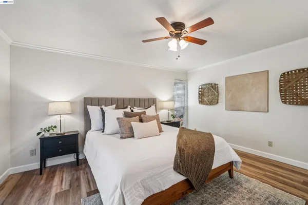 a bedroom with bed and wooden floor