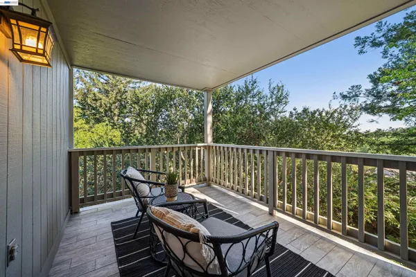 a view of a two chairs in the balcony