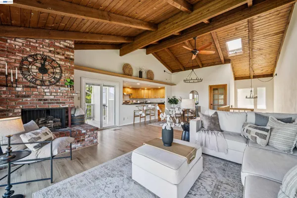 a living room with fireplace furniture and a large window