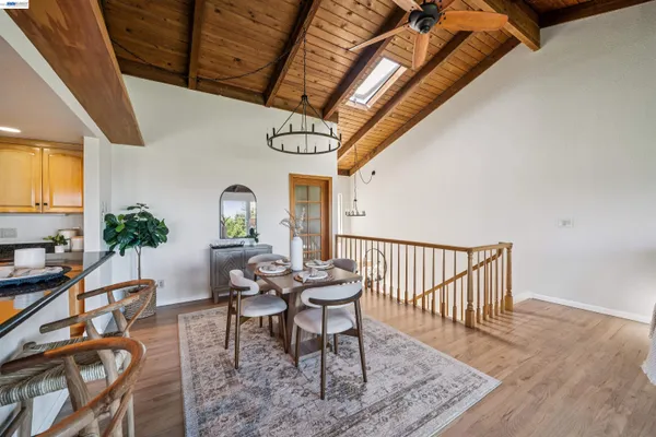 a dining room with furniture a rug and a chandelier