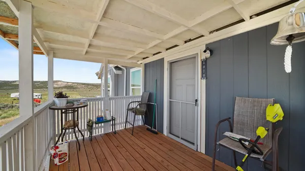 a living room with furniture a chandelier and a window