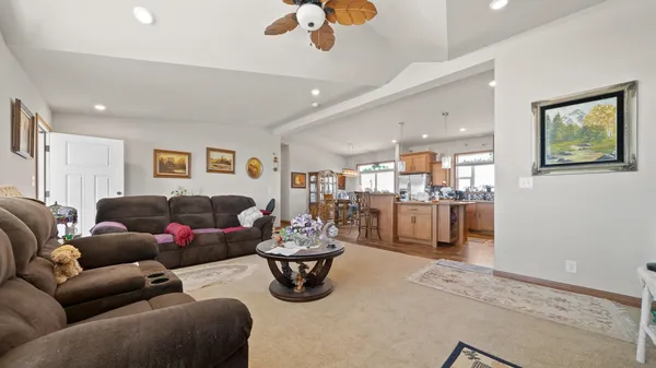 a kitchen with stainless steel appliances kitchen island granite countertop dining table chairs and granite counter tops