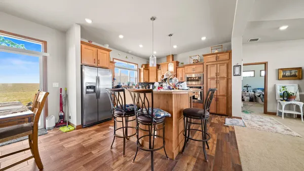 a kitchen with stainless steel appliances sink stove and cabinets
