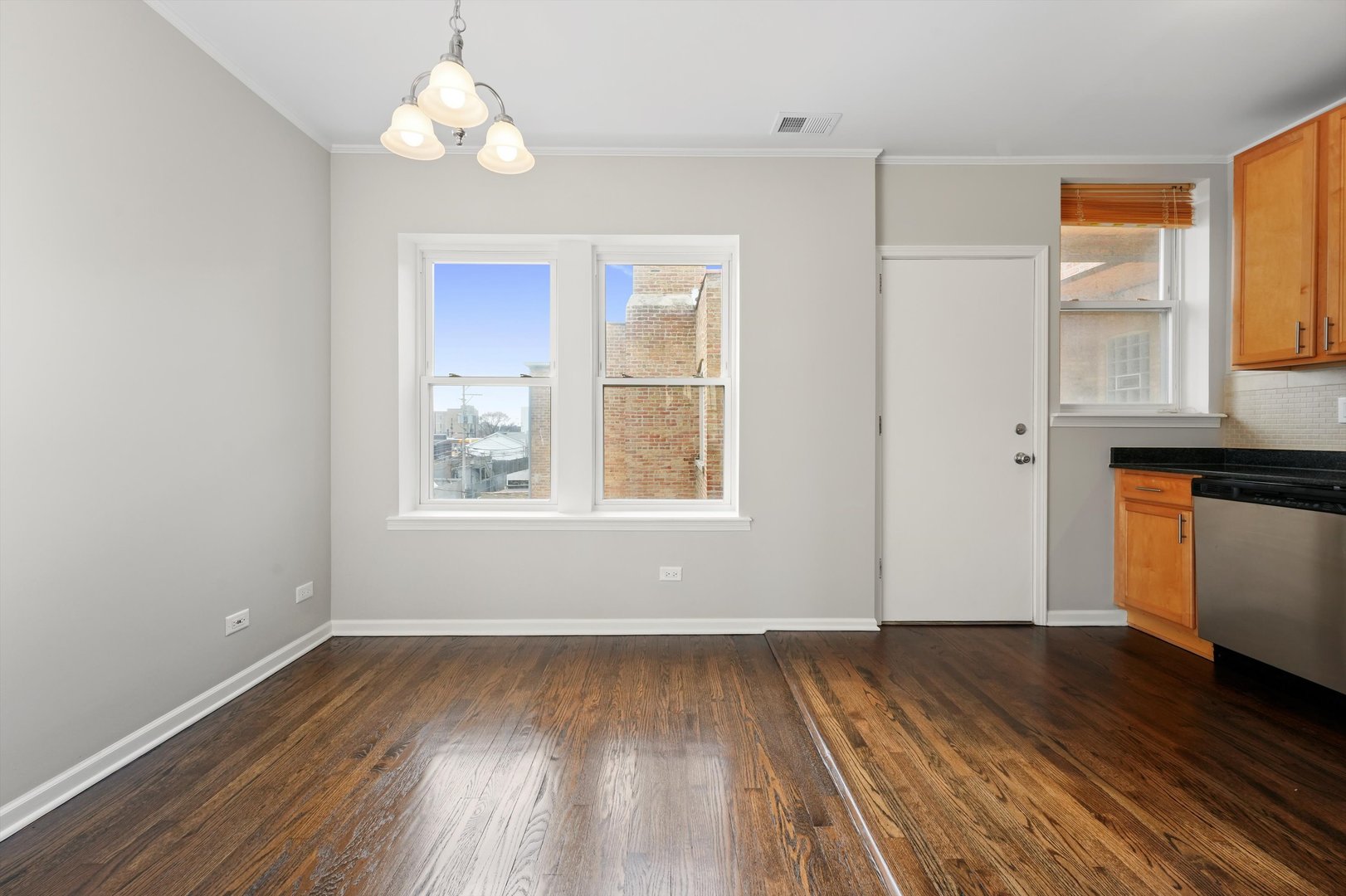 800 Dobson Street, Unit 3 Evanston, IL 60202 - Photo 12 of 26 wooden floor in an empty room with a window