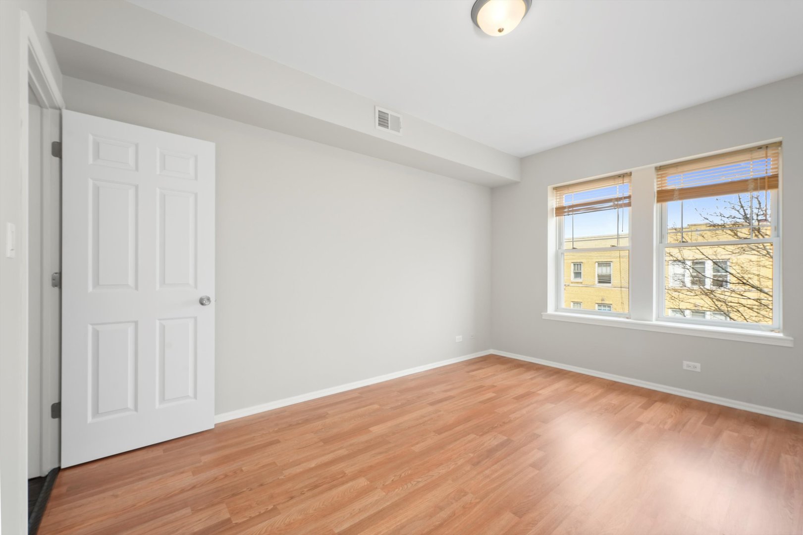 800 Dobson Street, Unit 3 Evanston, IL 60202 - Photo 15 of 26 a view of an empty room with wooden floor and a window
