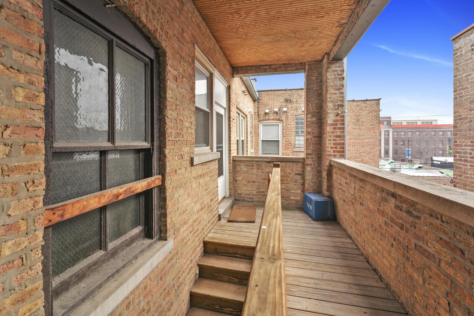 800 Dobson Street, Unit 3 Evanston, IL 60202 - Photo 22 of 26 a view of a balcony with wooden floor and iron stairs