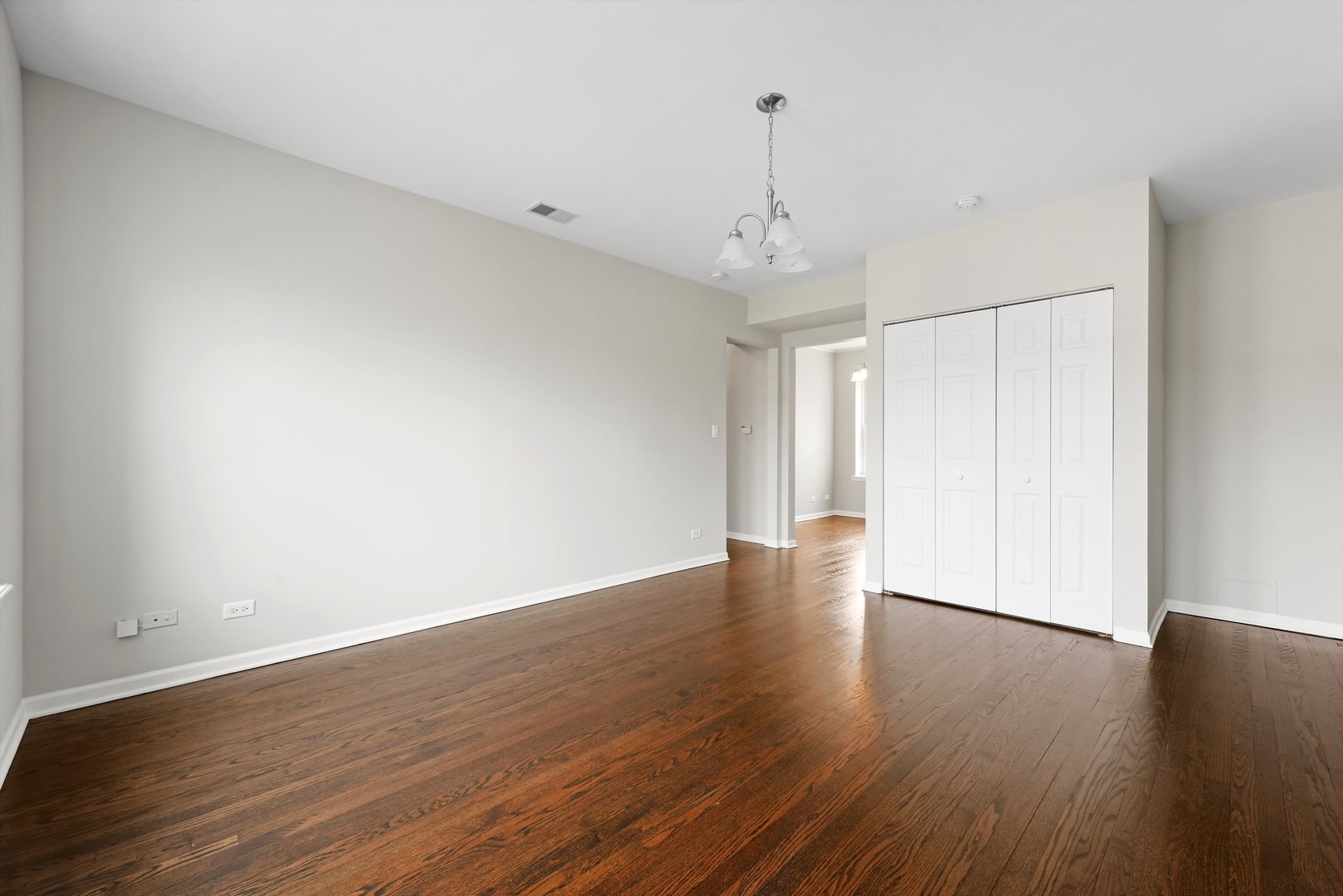 800 Dobson Street, Unit 3 Evanston, IL 60202 - Photo 4 of 26 a view of an empty room with wooden floor and a window