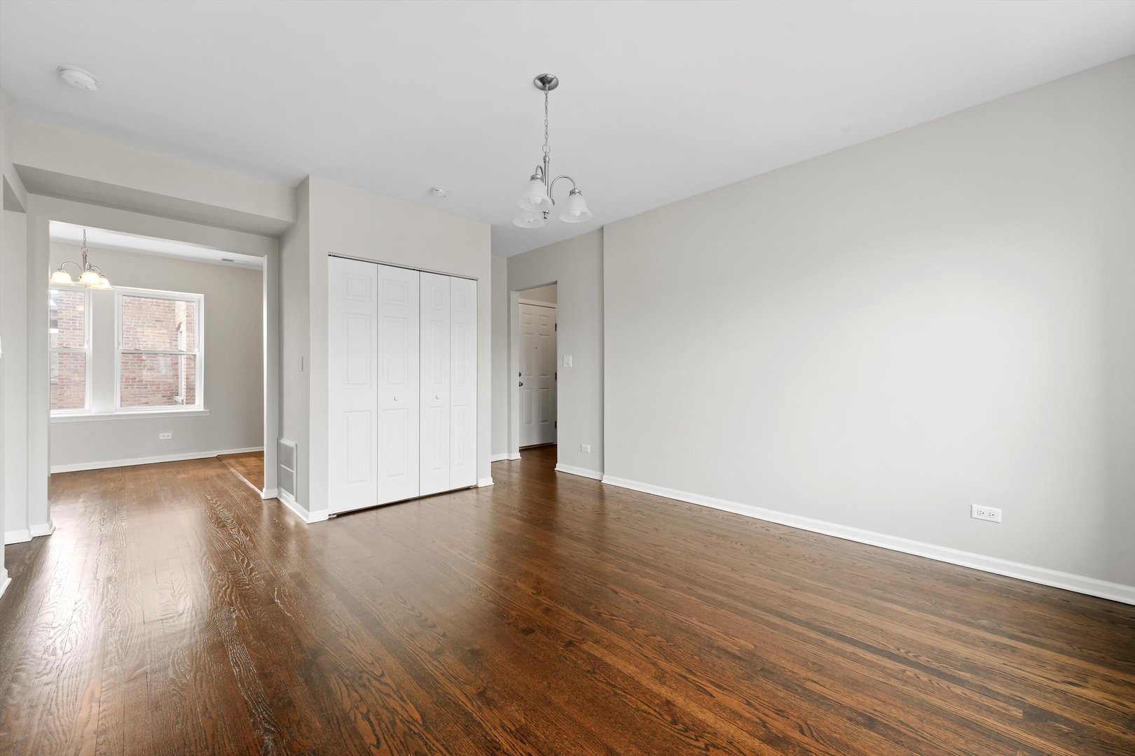 800 Dobson Street, Unit 3 Evanston, IL 60202 - Photo 5 of 26 a view of an empty room with wooden floor and a window