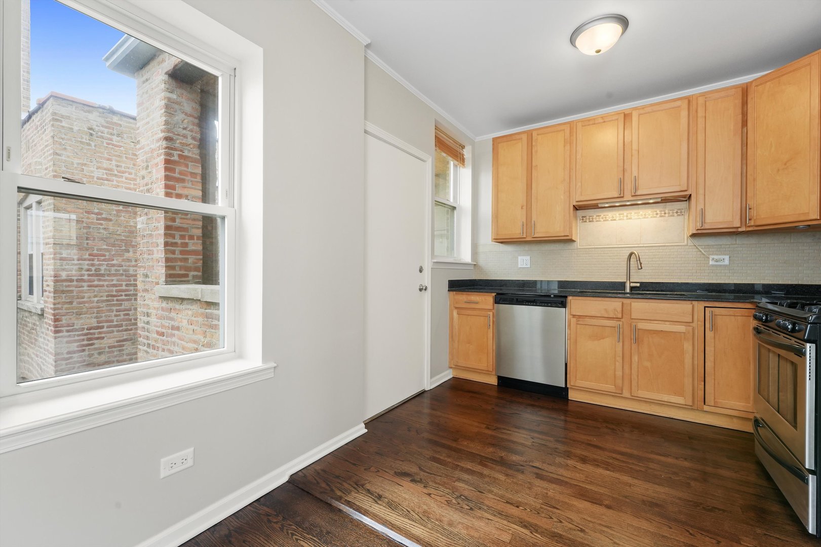 800 Dobson Street, Unit 3 Evanston, IL 60202 - Photo 7 of 26 a kitchen with a white cabinets and wooden floor