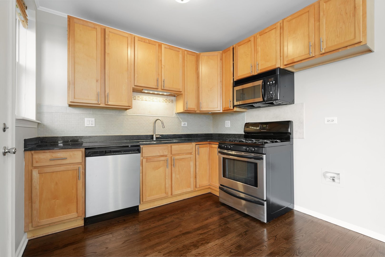 800 Dobson Street, Unit 3 Evanston, IL 60202 - Photo 8 of 26 a kitchen with stainless steel appliances granite countertop a stove a sink and a microwave