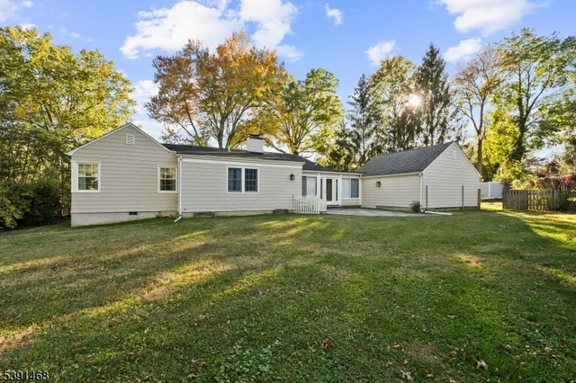 a view of a backyard with large trees