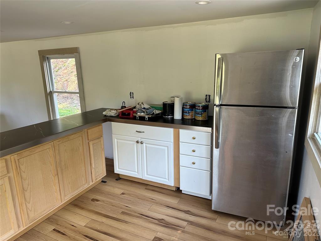 1385 Rock Spring Road Mill Spring, NC 28756 - Photo 11 of 15 a kitchen with stainless steel appliances a refrigerator sink and cabinets