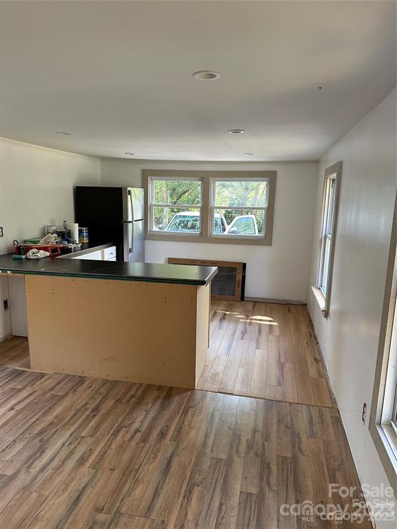 1385 Rock Spring Road Mill Spring, NC 28756 - Photo 12 of 15 a living room with stainless steel appliances hardwood floor and a large window