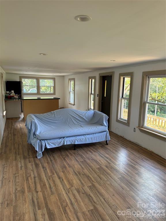 1385 Rock Spring Road Mill Spring, NC 28756 - Photo 13 of 15 a bedroom with a bed and wooden floor