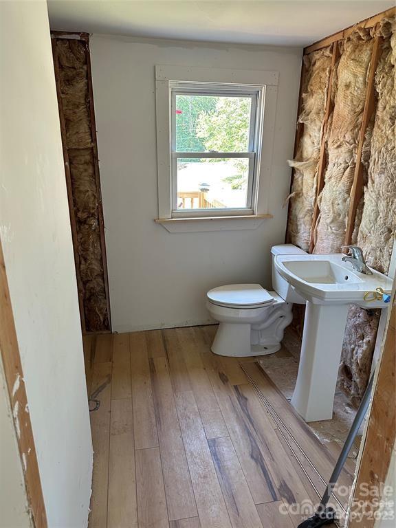 1385 Rock Spring Road Mill Spring, NC 28756 - Photo 15 of 15 a bathroom with a toilet and a window
