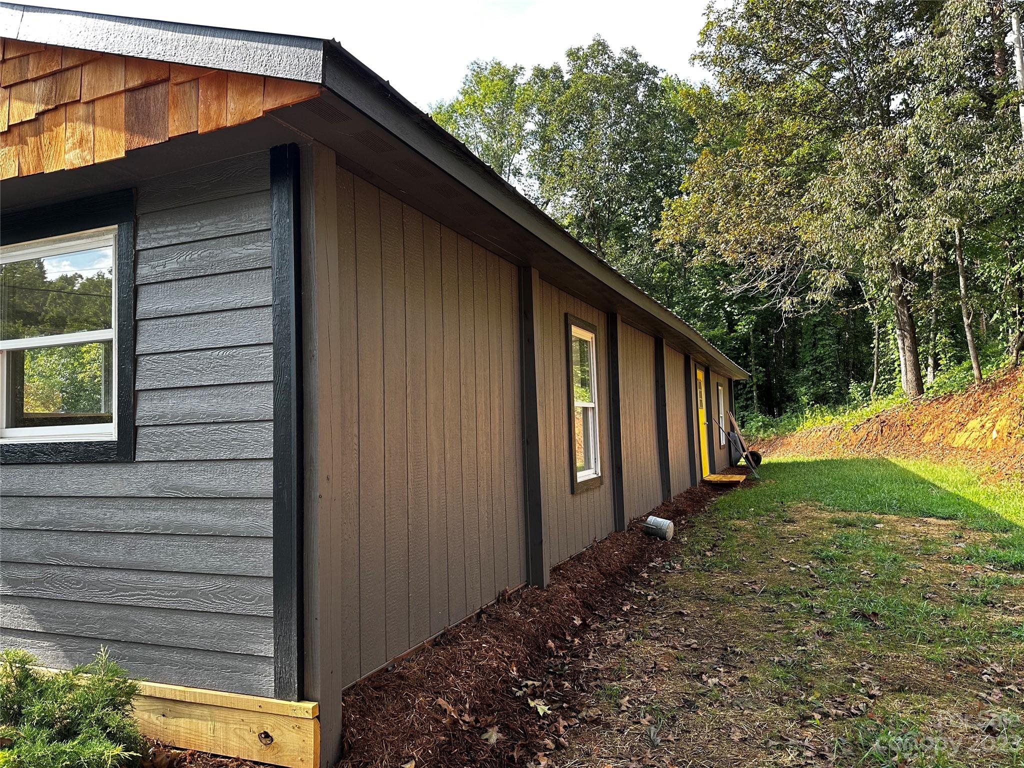 1385 Rock Spring Road Mill Spring, NC 28756 - Photo 2 of 15 a backyard of a house with lots of green space