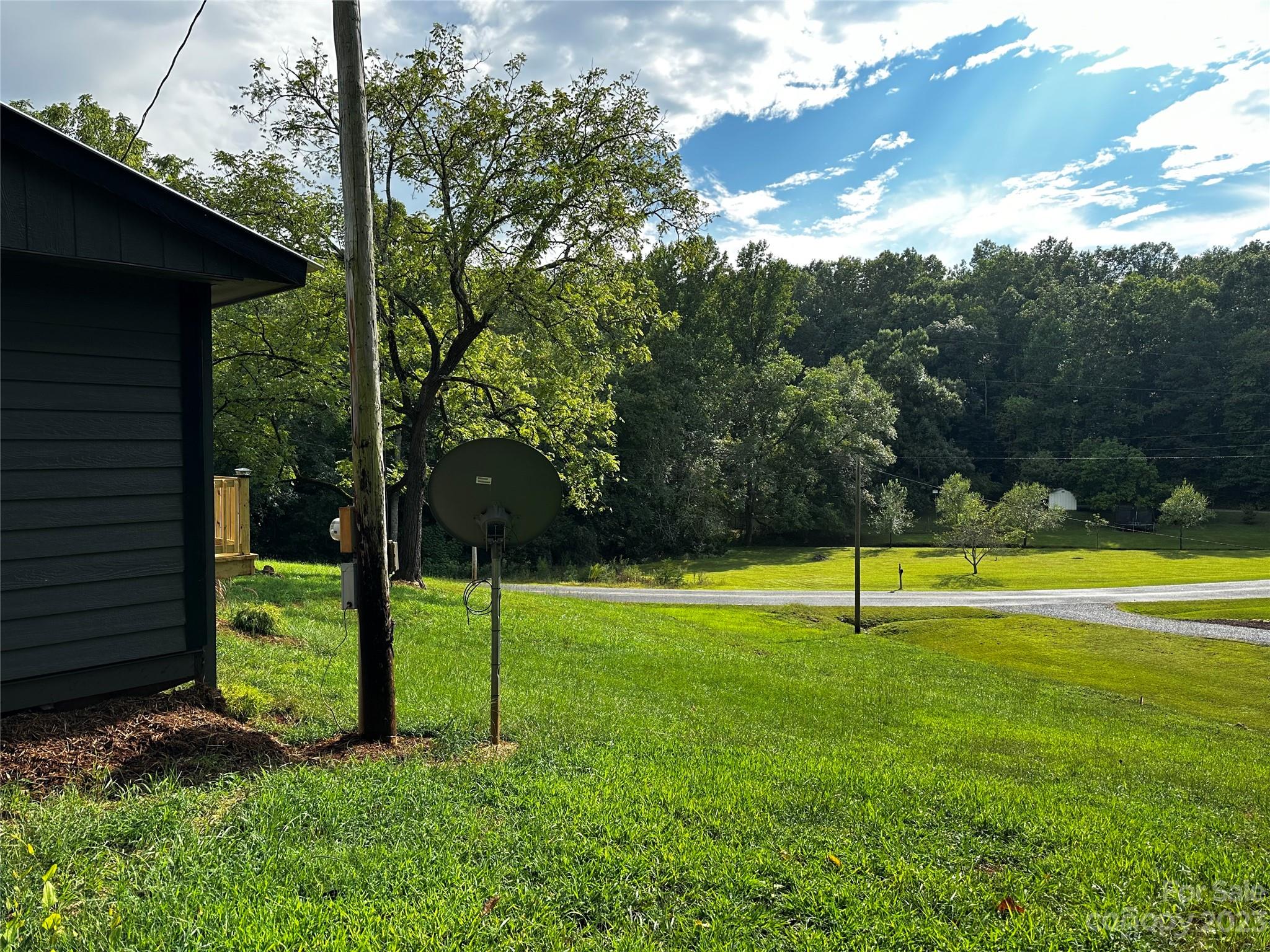 1385 Rock Spring Road Mill Spring, NC 28756 - Photo 6 of 15 a view of a big yard with swimming pool of the house
