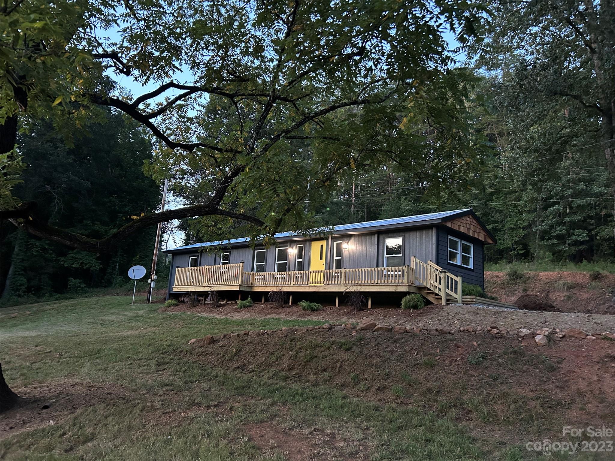 1385 Rock Spring Road Mill Spring, NC 28756 - Photo 7 of 15 a house with trees in front of it