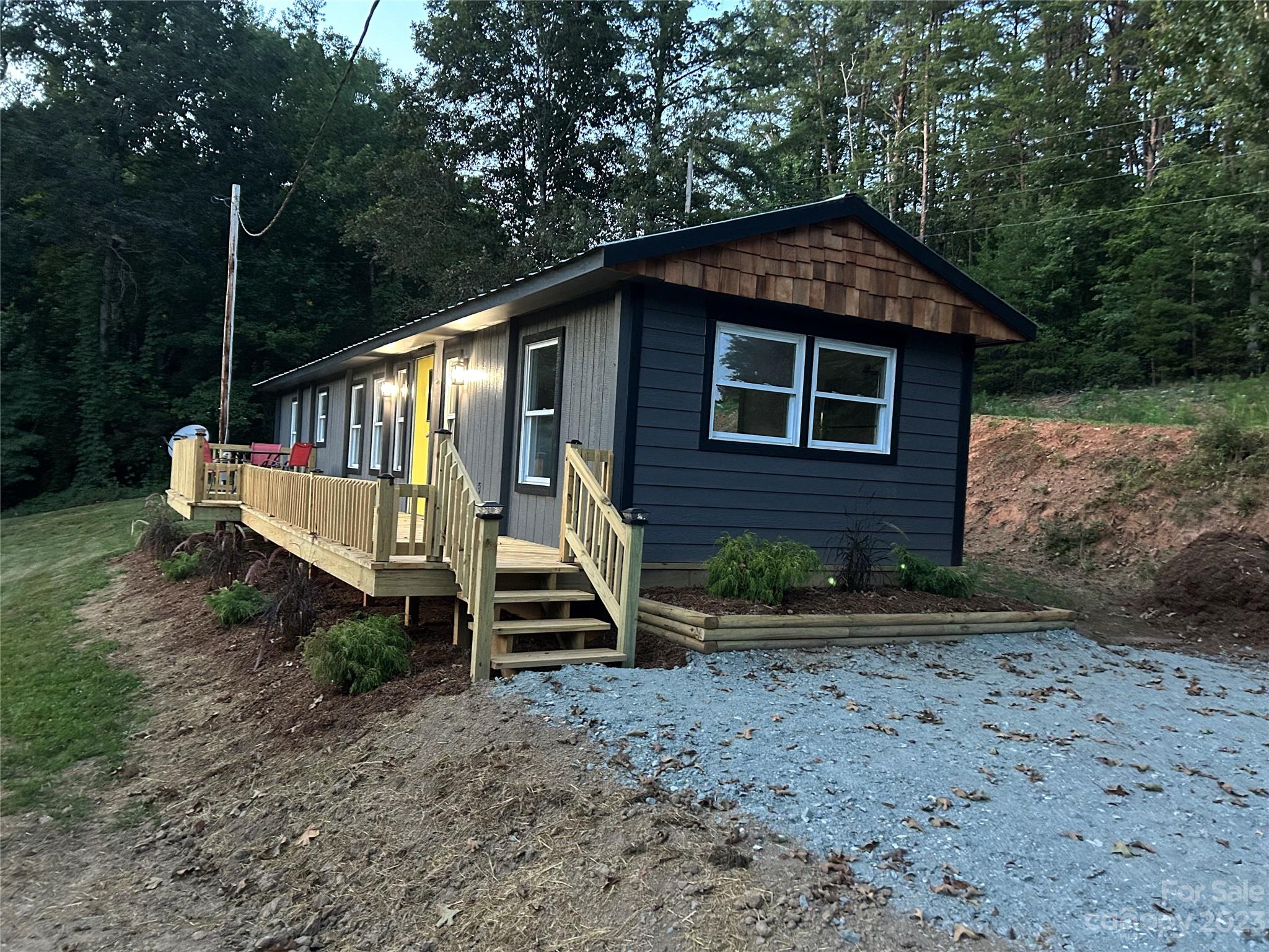 1385 Rock Spring Road Mill Spring, NC 28756 - Photo 8 of 15 a front view of a house with a yard
