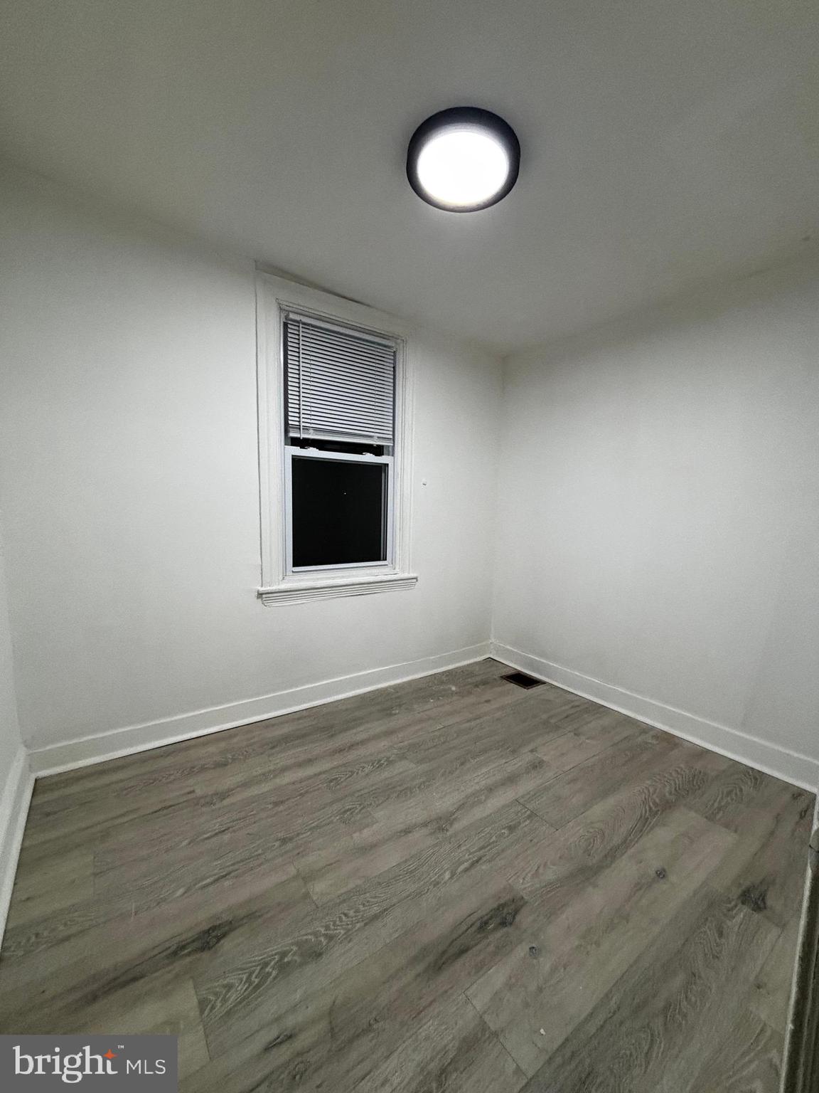 2116 East Cambria Street Philadelphia, PA 19134 - Photo 7 of 9 an empty room with wooden floor and windows