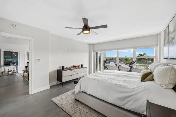a bedroom with a bed couch and a window