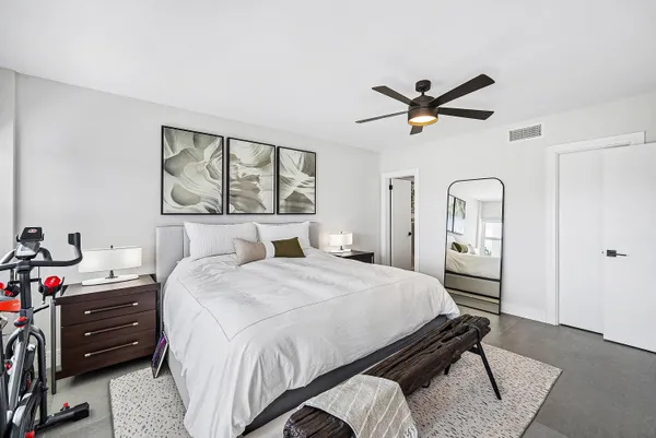 a bedroom with a bed dresser and a window