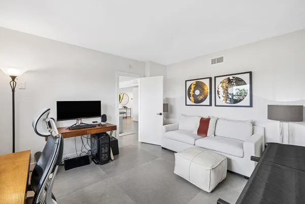 a bedroom with furniture and a flat screen tv