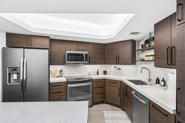 a kitchen with a sink stainless steel appliances and cabinets