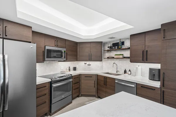 a kitchen with a sink stainless steel appliances and cabinets