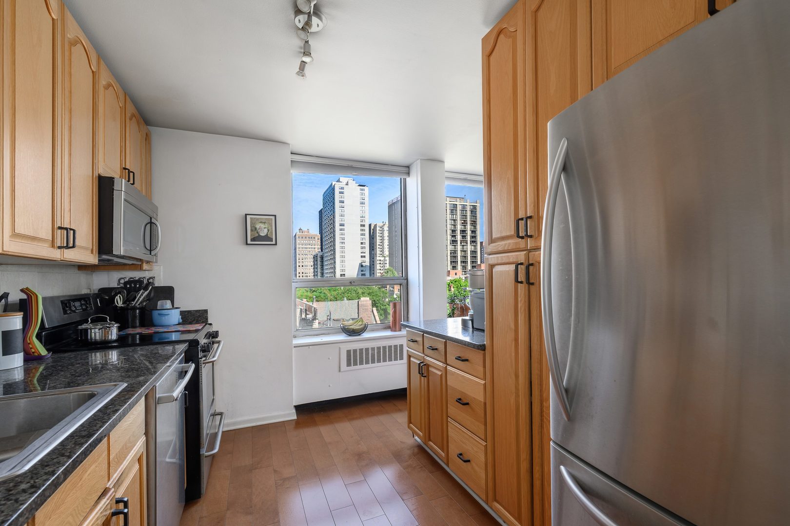 70 West Burton Place, Unit 705 Chicago, IL 60610 - Photo 10 of 17 a kitchen with stainless steel appliances a refrigerator and a stove
